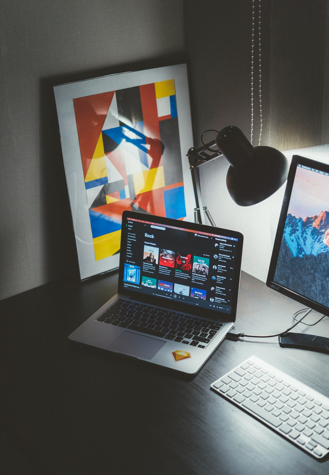 who-we-are turned-on-macbook-on-table-beside-imac-g-yix8ynmny
